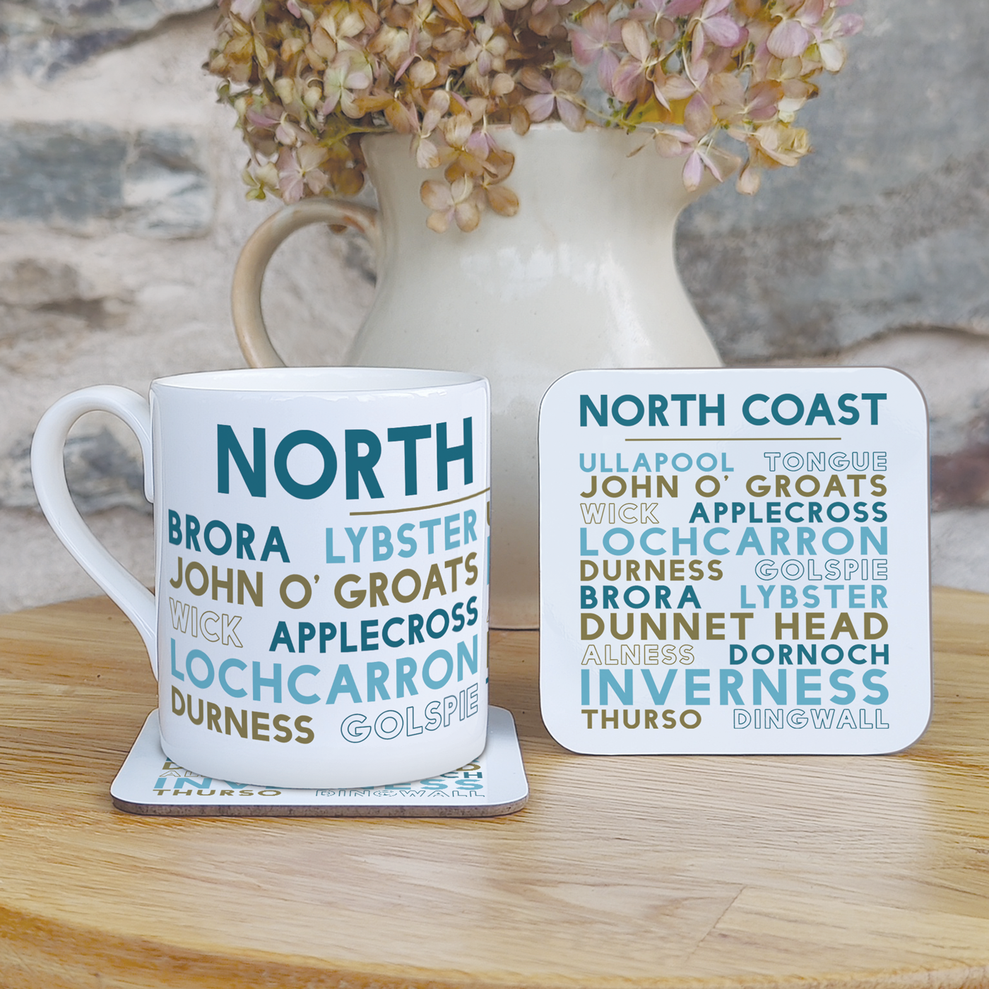 Mug and coaster set with locations around the North Coast of Scotland on a wooden surface