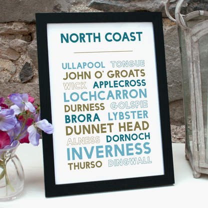 Print with names of places around the North Coast of Scotland in a black frame, standing on a table