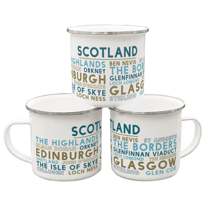 Three Scottish Attractions enamel mugs, decorated with the names of various places and visitor attractions in Scotland, stacked in to a pyramid against a white background