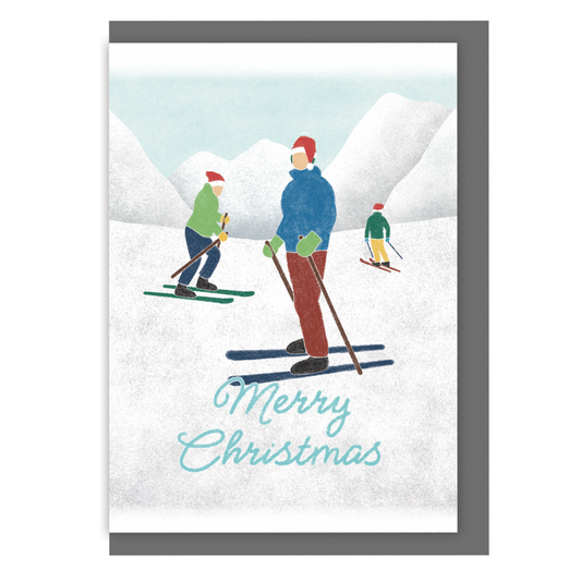 Skiing Christmas card with three skiers in Santa hats and the text 'Merry Christmas', on a white background