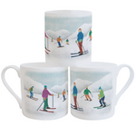 White fine bone china mugs with an illustration of colourful skiers in front of snow-covered mountains, stacked against a white background